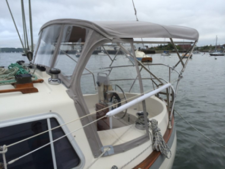 Boat dodger with attached bimini top