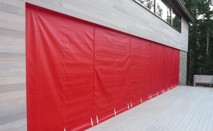 Red Wall of canvas protecting glass wall over Winter